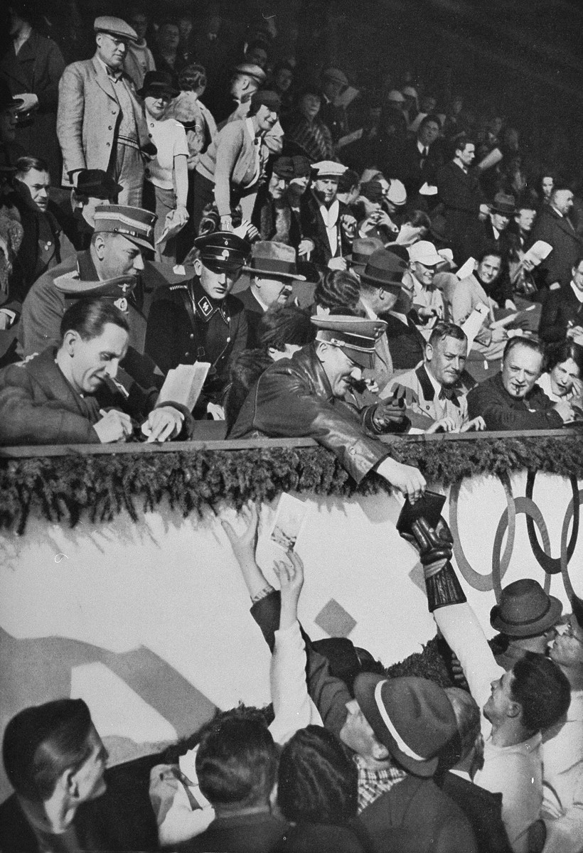 Adolf Hitler and Joseph Goebbels sign autographs on the occasion of the Hockey match between Canada and United States at the Winter Olympics